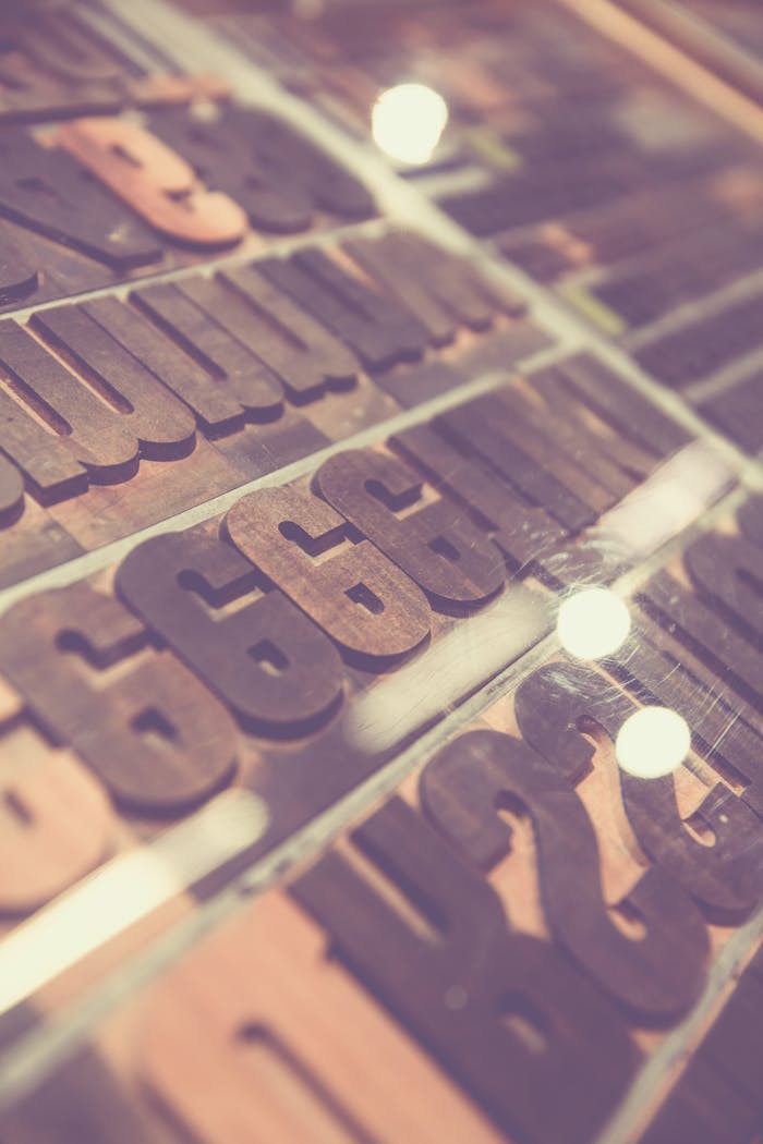 Close-up of vintage wooden letterpress type blocks on display.