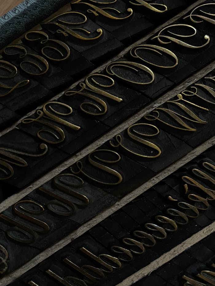 Detailed view of vintage metal type letters used in traditional printing.
